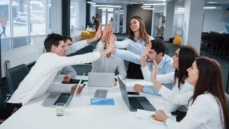 A team is celebrating the business success for agent led growth